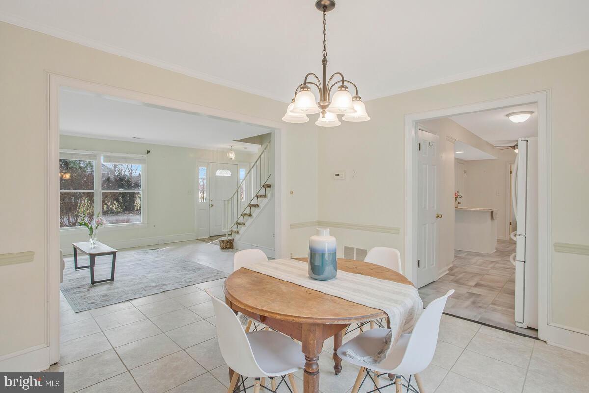 6155 Sandy Point Road Prince Frederick, MD 20678 - Photo 10 of 50 a view of a dining room with furniture and chandelier