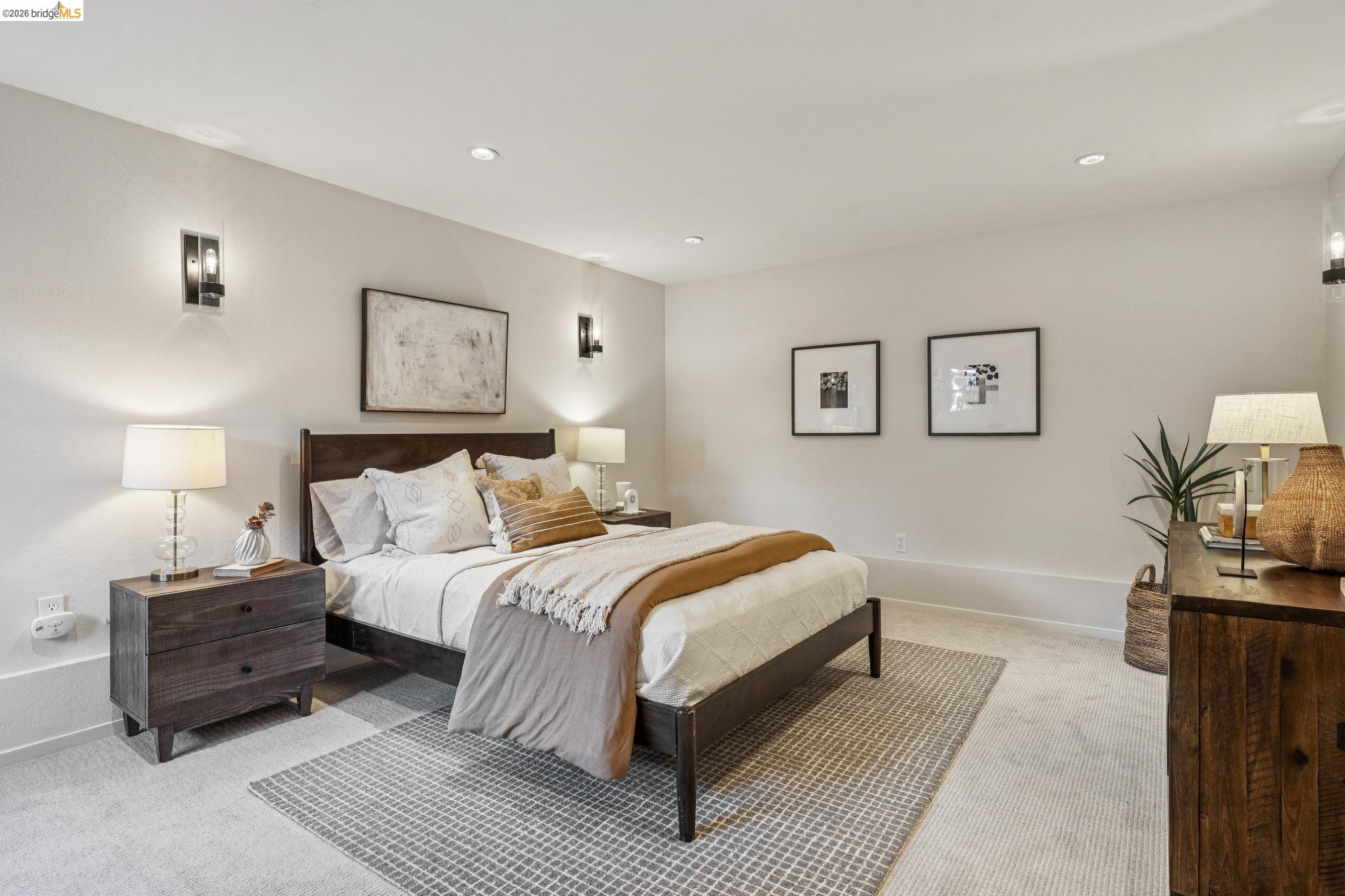 5275 Proctor Avenue Oakland, CA 94618 - Photo 31 of 43 a bedroom with a bed lamp and paintings on the wall