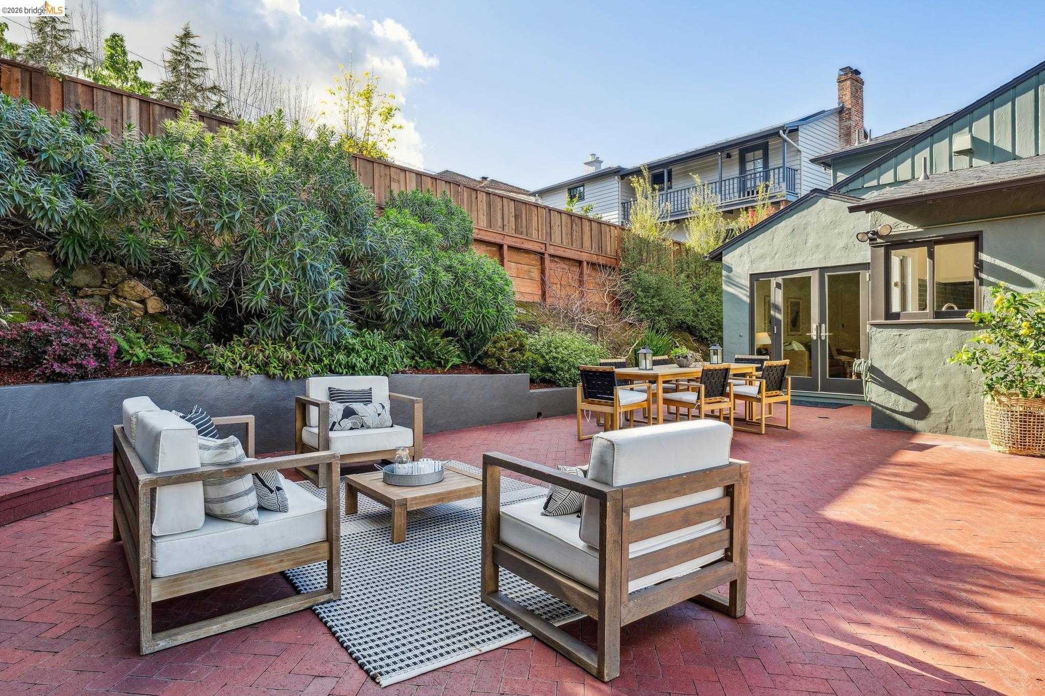 5275 Proctor Avenue Oakland, CA 94618 - Photo 35 of 43 a view of a patio with couches and a table and chairs with wooden floor