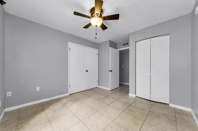 a view of empty room with ceiling fan