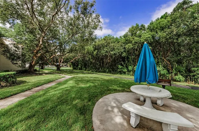 a view of swimming pool with a yard and plants