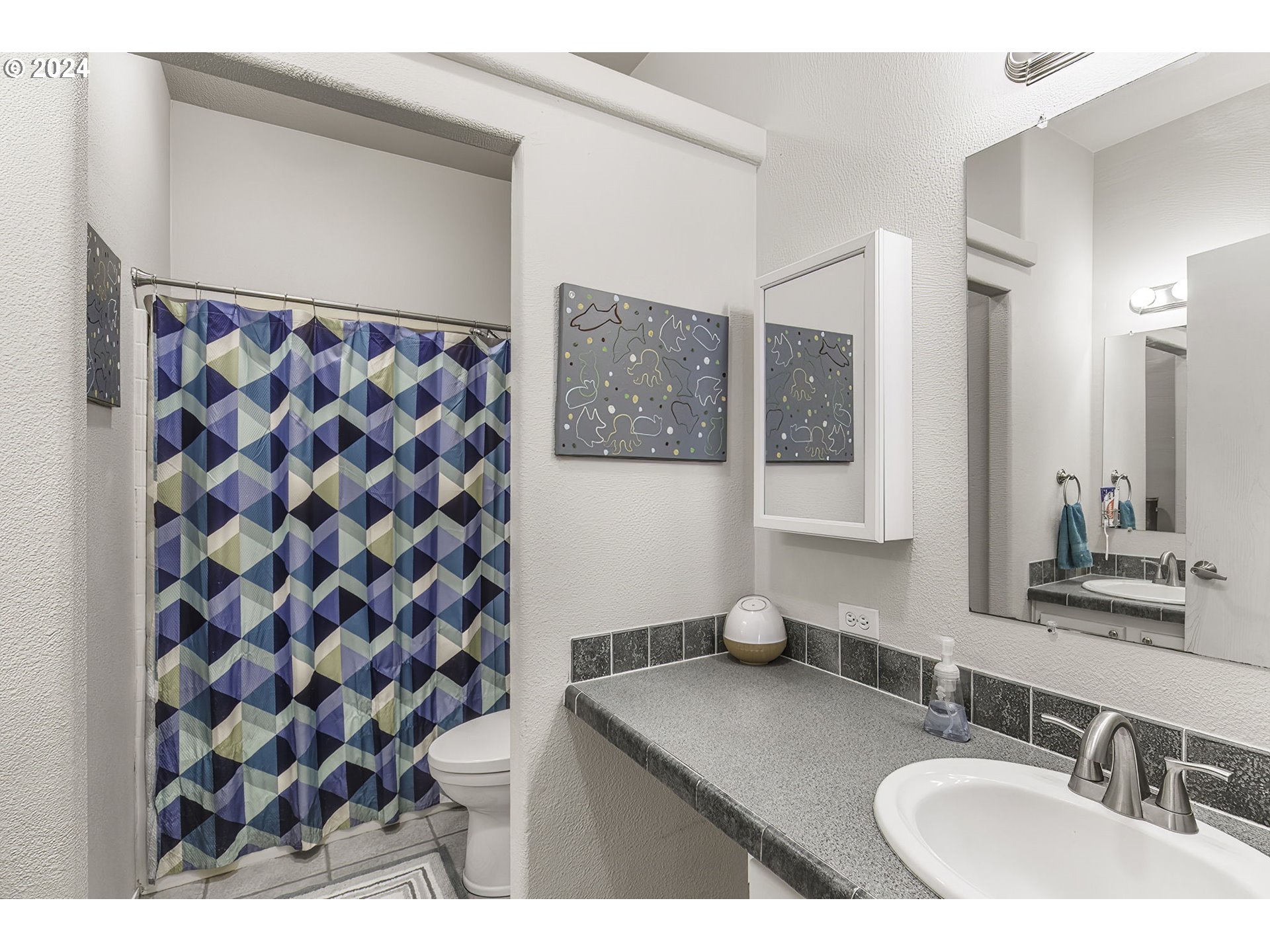 110-81 Rawlins Road Winlock, WA 98596 - Photo 20 of 32 a bathroom with a sink toilet and shower
