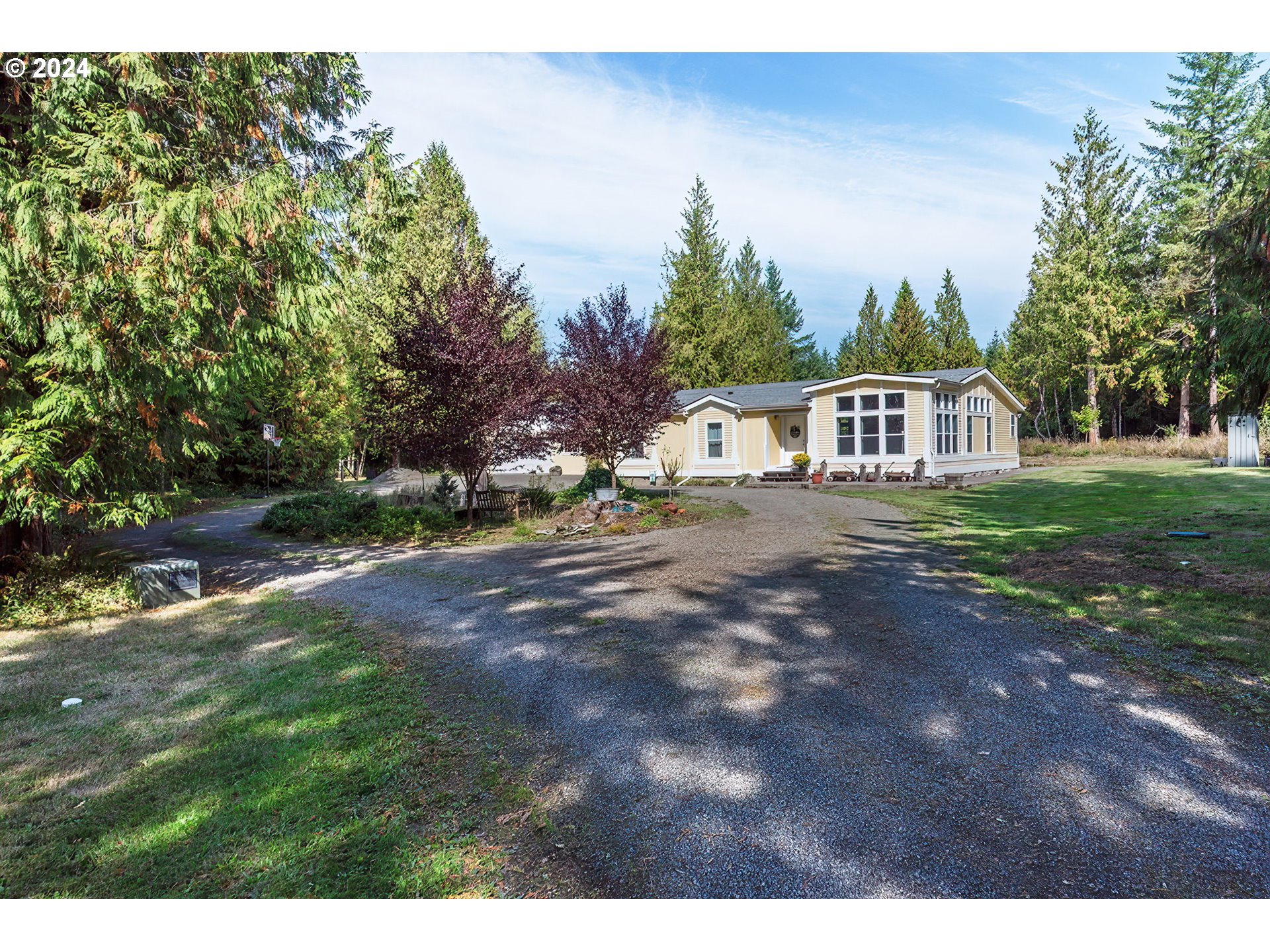 110-81 Rawlins Road Winlock, WA 98596 - Photo 2 of 32 a view of an house with backyard and trees
