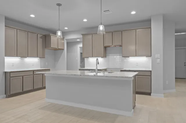 a kitchen with kitchen island granite countertop a sink stainless steel appliances and white cabinets