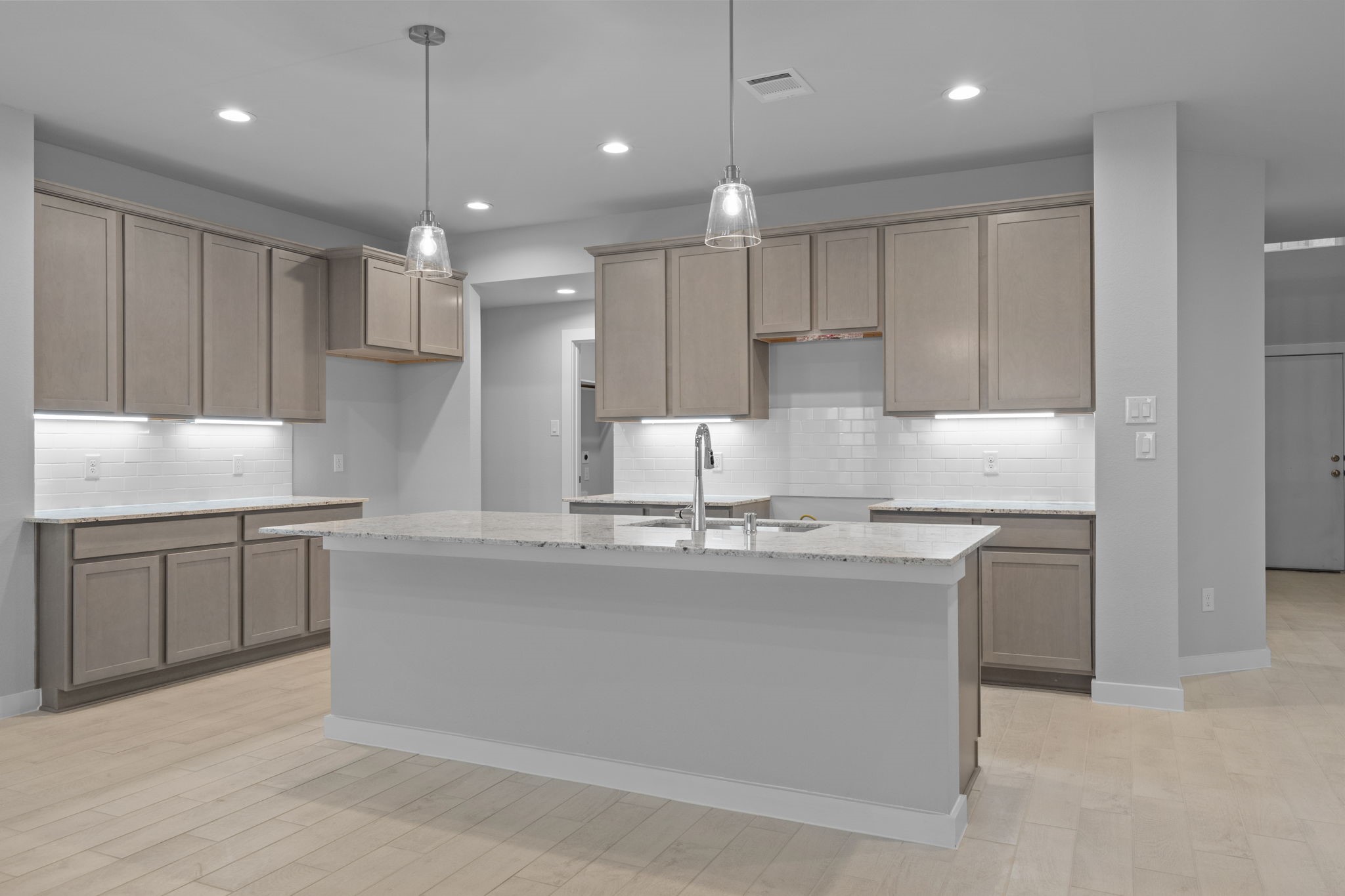 619 Yard Master Trail Rosharon, TX 77583 - Photo 4 of 46 a kitchen with kitchen island granite countertop a sink stainless steel appliances and white cabinets