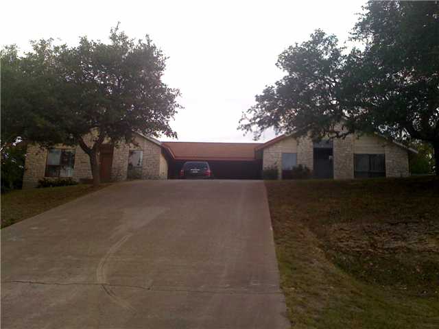 Exterior Front : Home tucked away from the road giving you plenty of privacy.  Also located on a cul-de-sac so you do not have to worry about traffic! Heavily treed lot with great stone front entry.