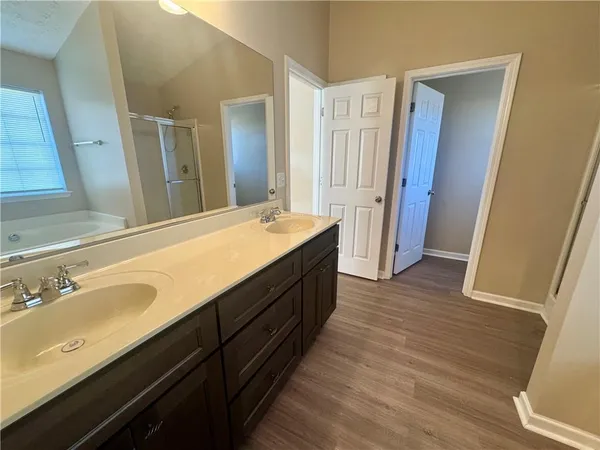 a spacious bathroom with a double vanity sink and a mirror