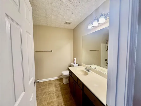 a bathroom with a sink a mirror and a shower