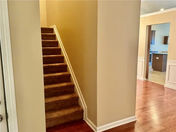 a view of a hallway with wooden floor and entryway
