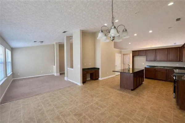 a view of a kitchen with a sink and a fireplace