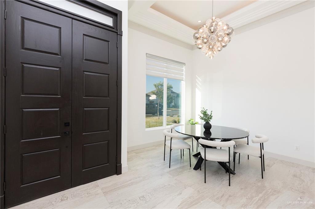 1505 Mount Street Mission, TX 78572 - Photo 11 of 25 Dining room with crown molding, a chandelier, and a tray ceiling