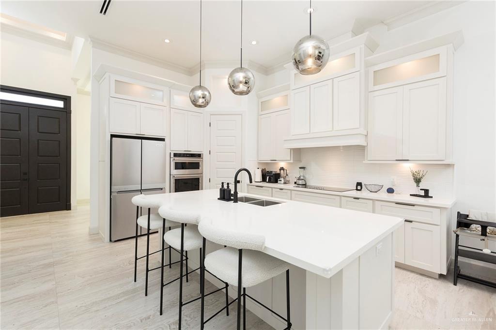 1505 Mount Street Mission, TX 78572 - Photo 12 of 25 Kitchen with white cabinetry, an island with sink, sink, and hanging light fixtures