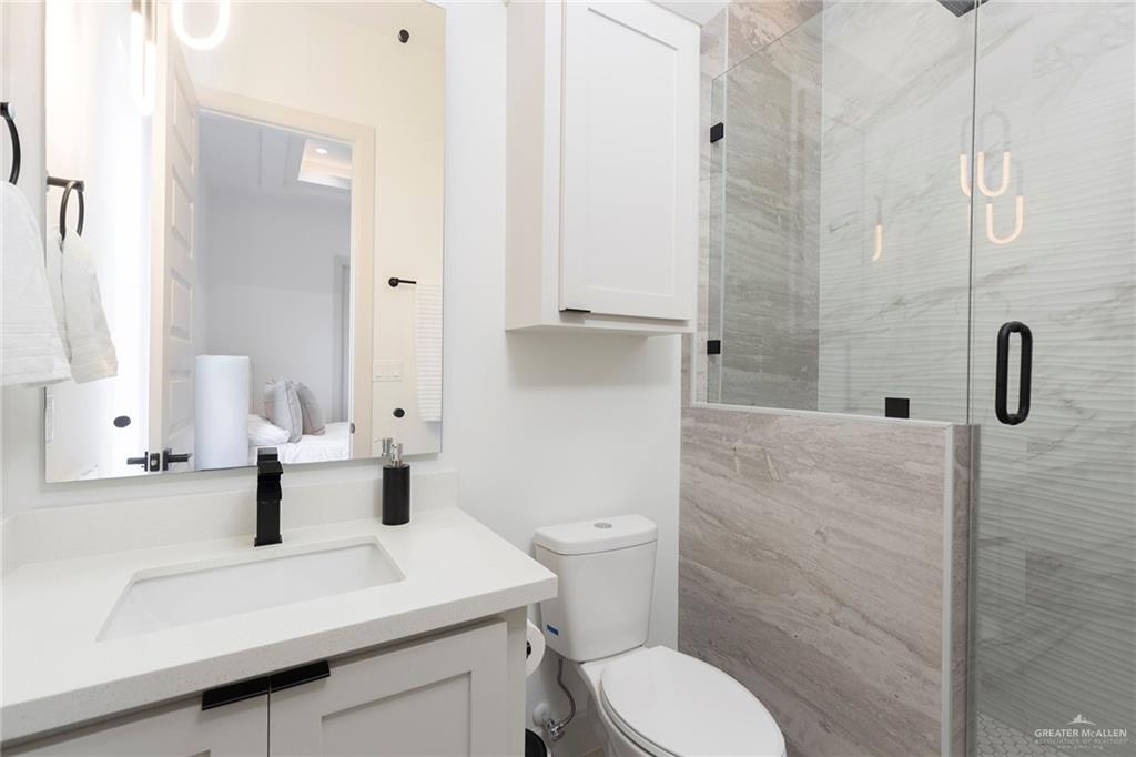 1505 Mount Street Mission, TX 78572 - Photo 16 of 25 Bathroom with vanity, walk in shower, and toilet