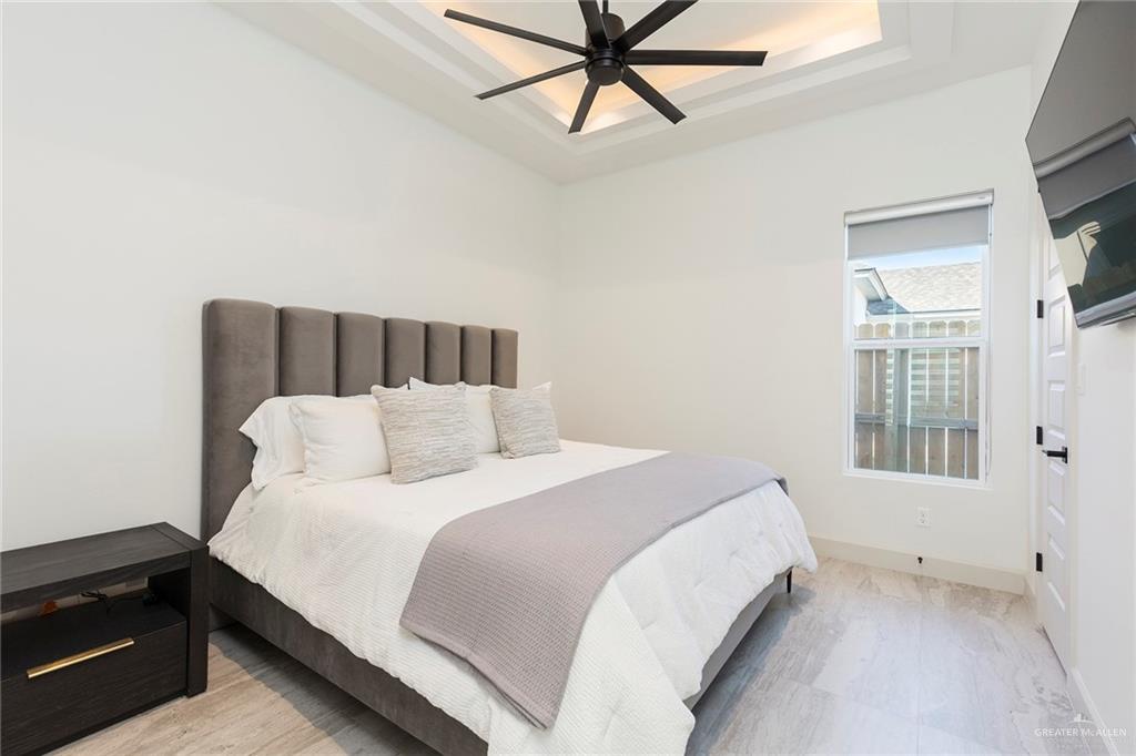 1505 Mount Street Mission, TX 78572 - Photo 17 of 25 Bedroom with ceiling fan and a tray ceiling