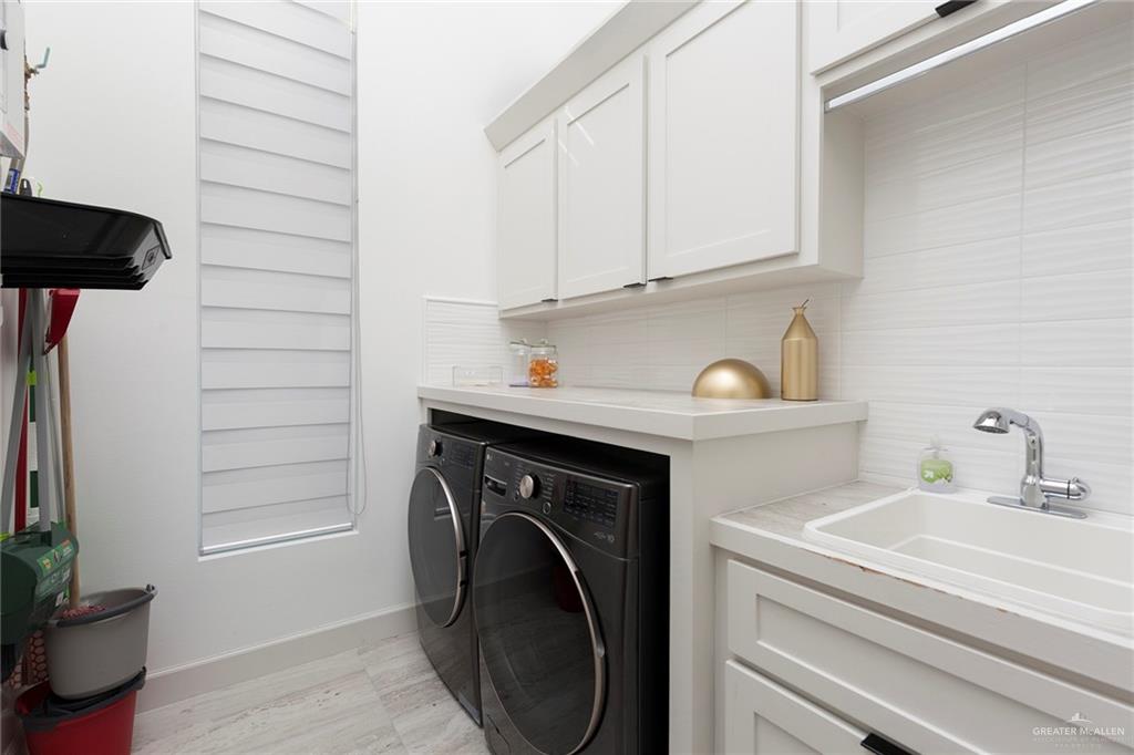 1505 Mount Street Mission, TX 78572 - Photo 20 of 25 Laundry room featuring cabinets, sink, and independent washer and dryer