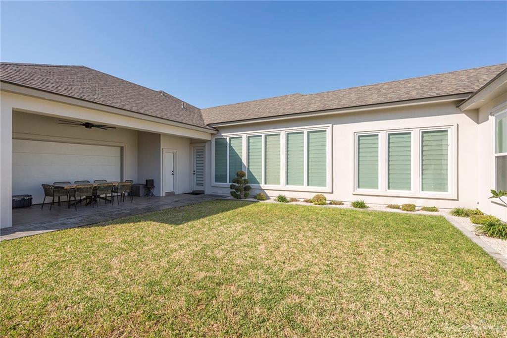 1505 Mount Street Mission, TX 78572 - Photo 2 of 25 Rear view of property with ceiling fan, a patio, and a lawn