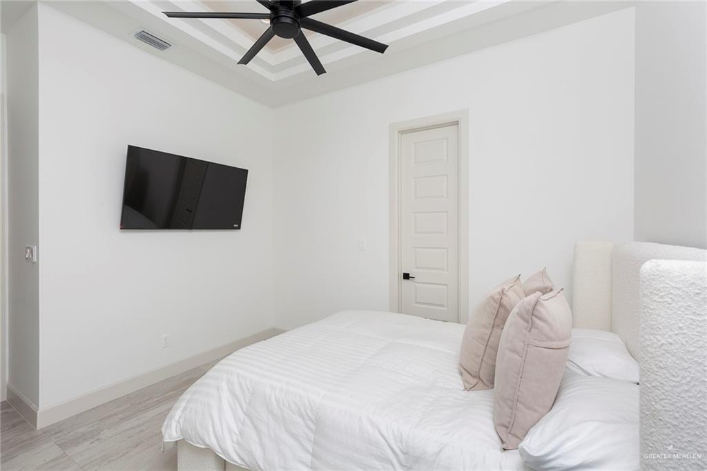 1505 Mount Street Mission, TX 78572 - Photo 25 of 25 Bedroom featuring a raised ceiling, ceiling fan, and light hardwood / wood-style flooring