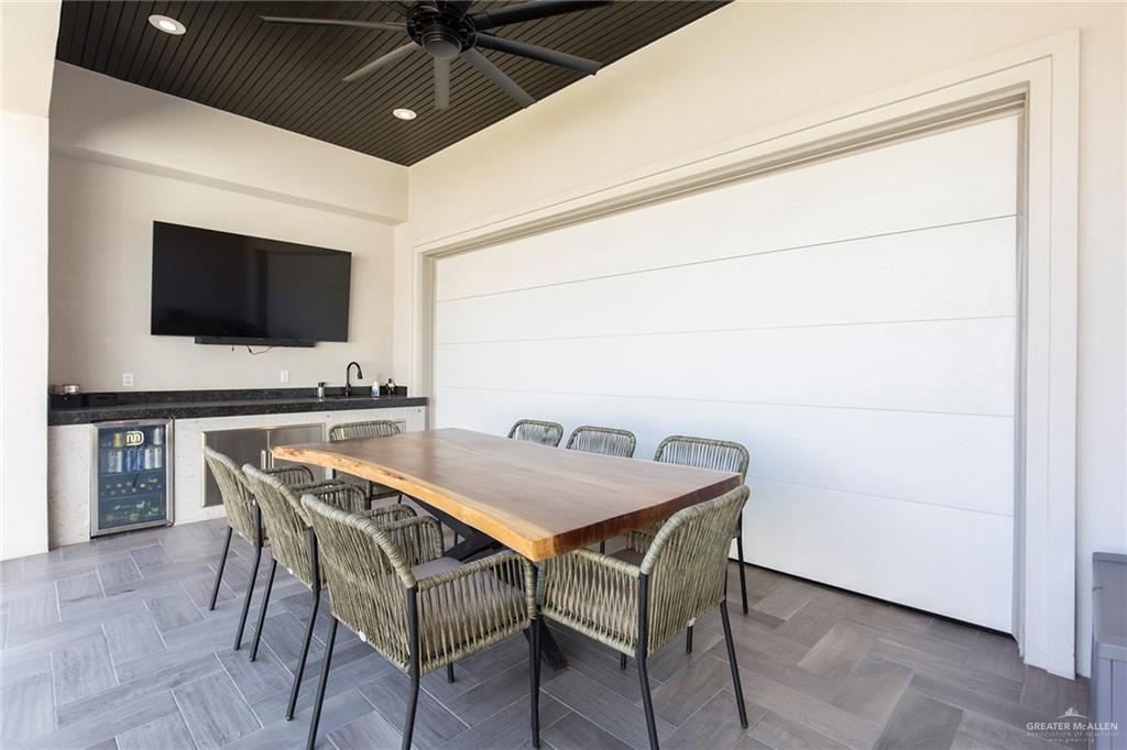 1505 Mount Street Mission, TX 78572 - Photo 4 of 25 Dining room with wine cooler, dark parquet flooring, ceiling fan, and bar
