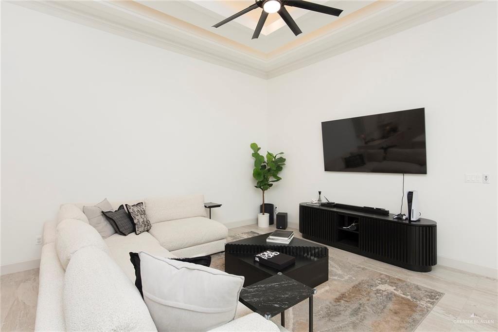 1505 Mount Street Mission, TX 78572 - Photo 7 of 25 Living room with crown molding, ceiling fan, and a tray ceiling