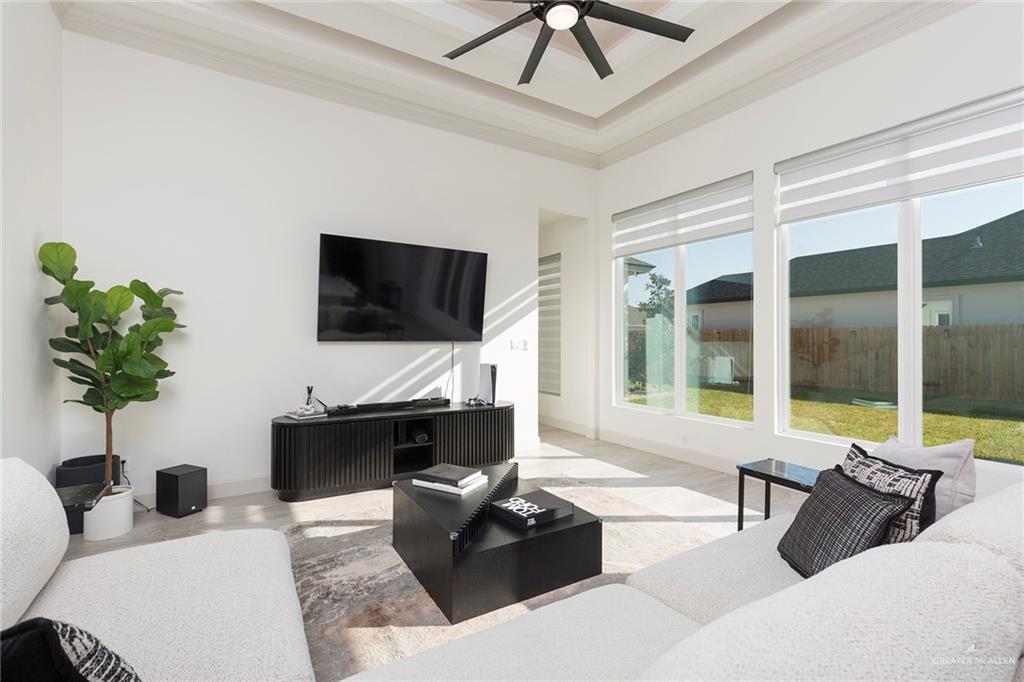 1505 Mount Street Mission, TX 78572 - Photo 9 of 25 Living room featuring a tray ceiling, crown molding, and ceiling fan