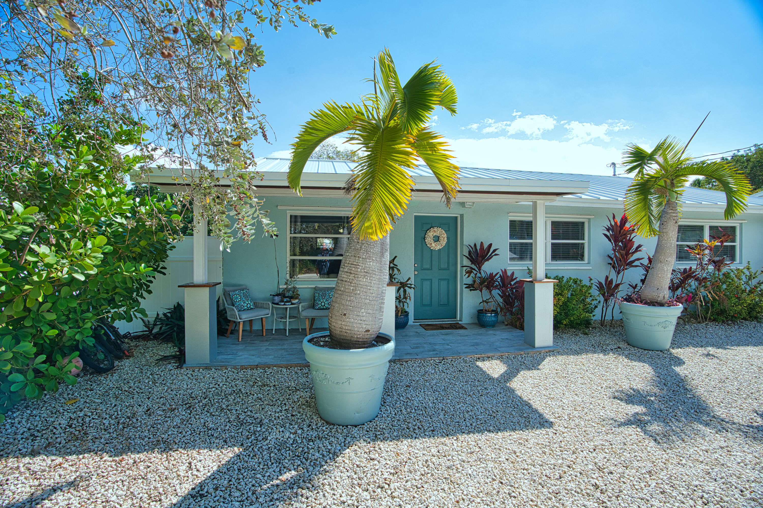 136 1st Road Key Largo, FL 33037 - Photo 12 of 45 a view of a patio with table and chairs and potted plants
