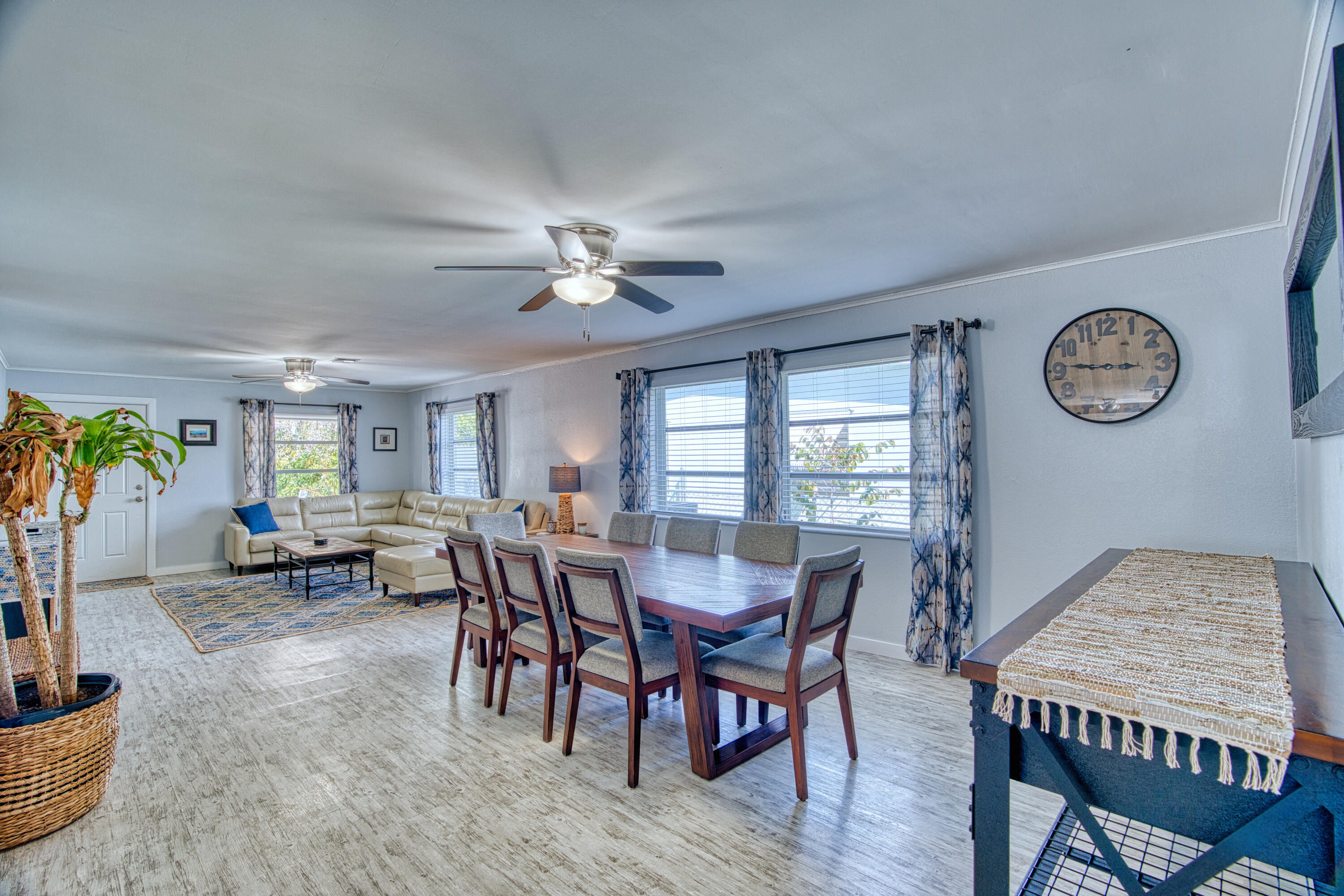 136 1st Road Key Largo, FL 33037 - Photo 16 of 45 a view of a dining room and livingroom with furniture a rug a fireplace and a chandelier