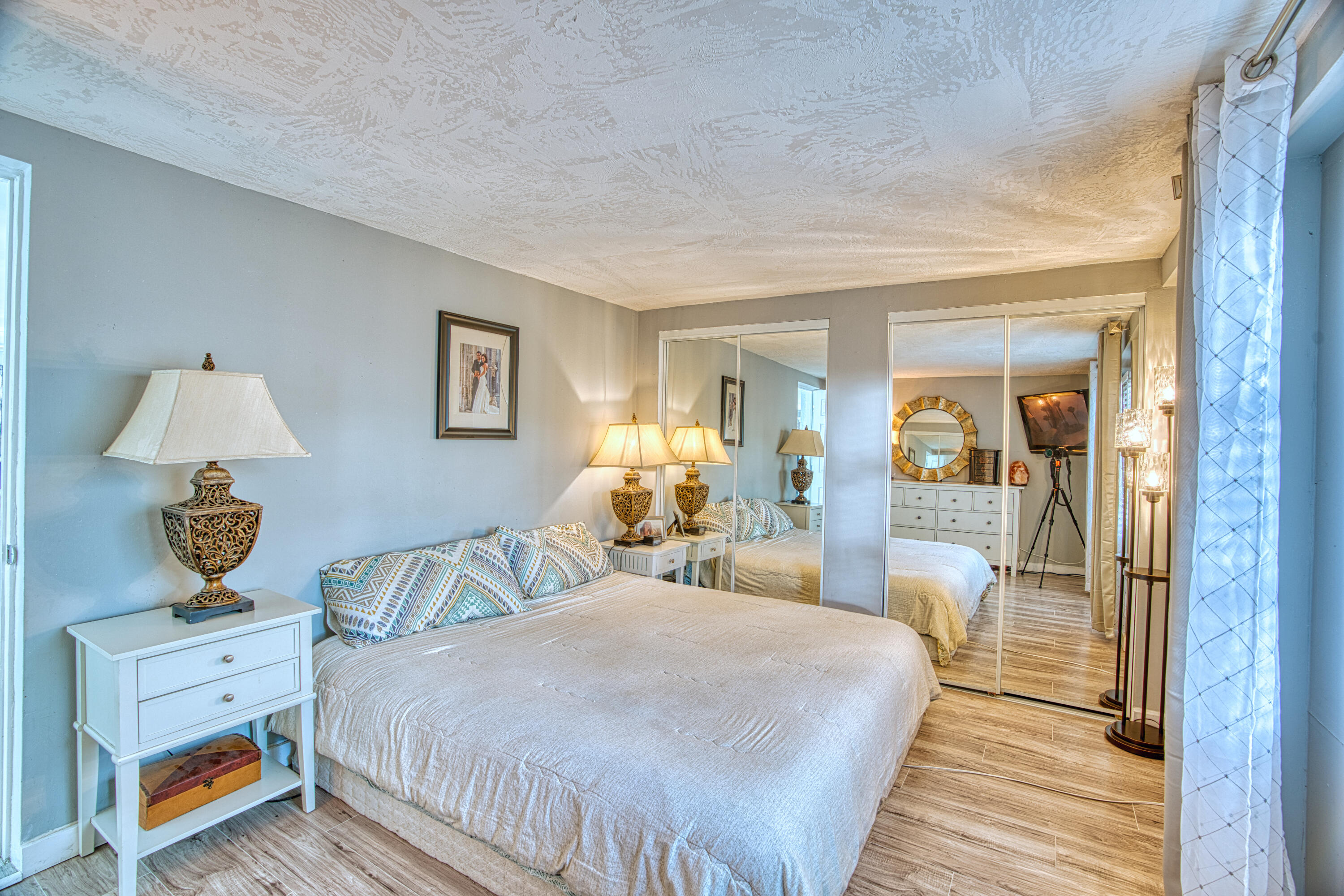 136 1st Road Key Largo, FL 33037 - Photo 32 of 45 a bedroom with a bed and wooden floor