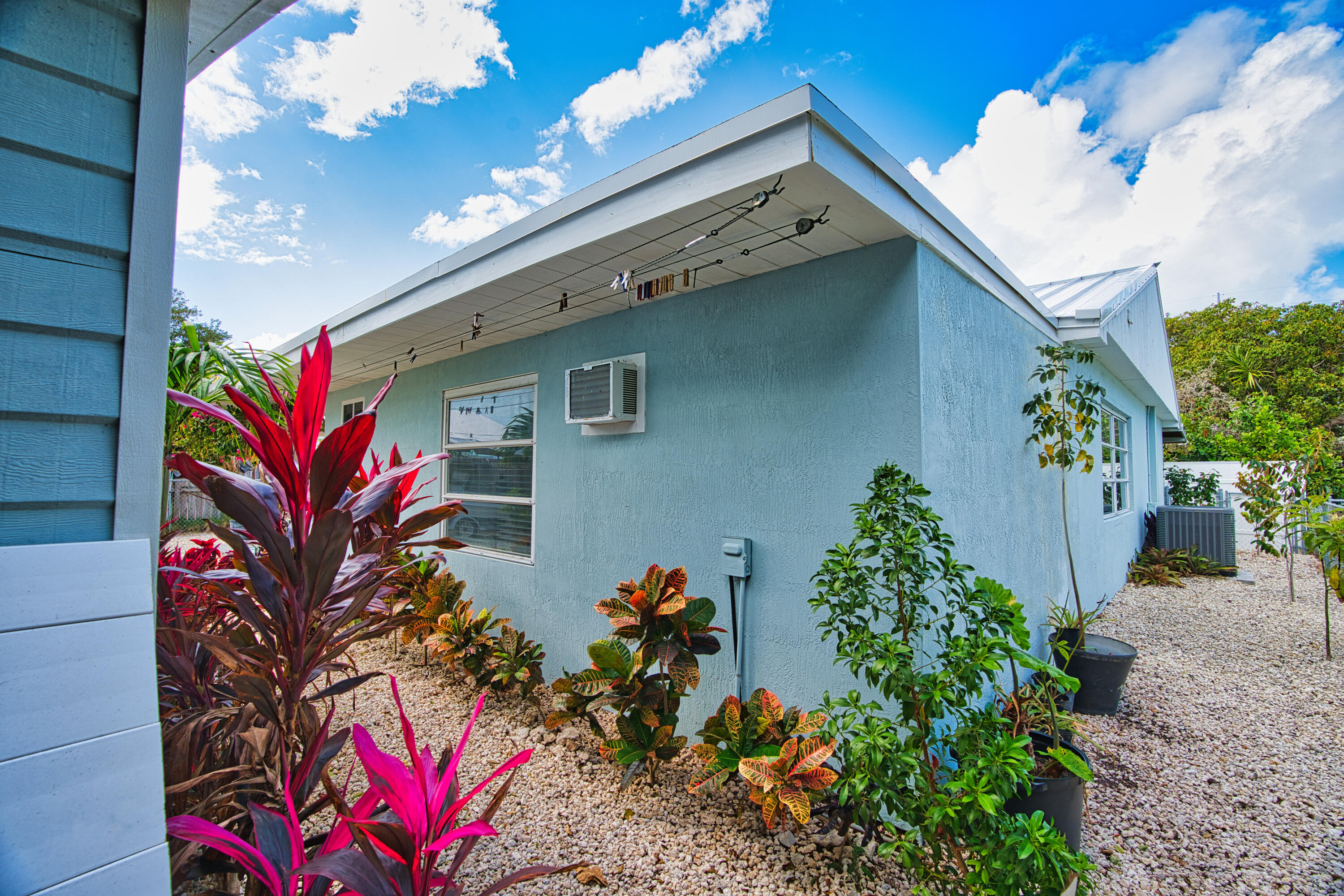 136 1st Road Key Largo, FL 33037 - Photo 43 of 45 a house with a flower garden in front of it