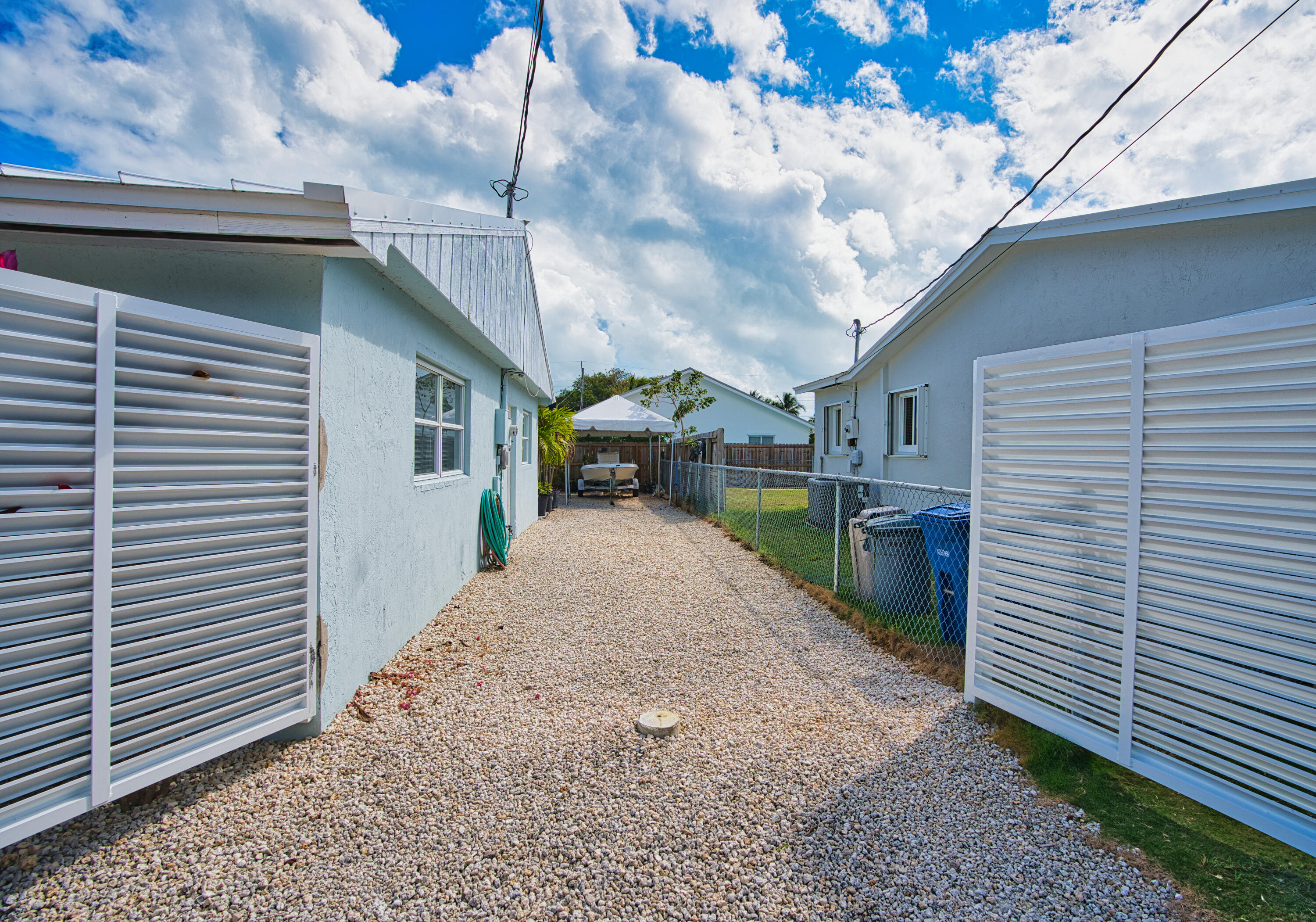 136 1st Road Key Largo, FL 33037 - Photo 8 of 45 a view of a backyard with plants and a garage