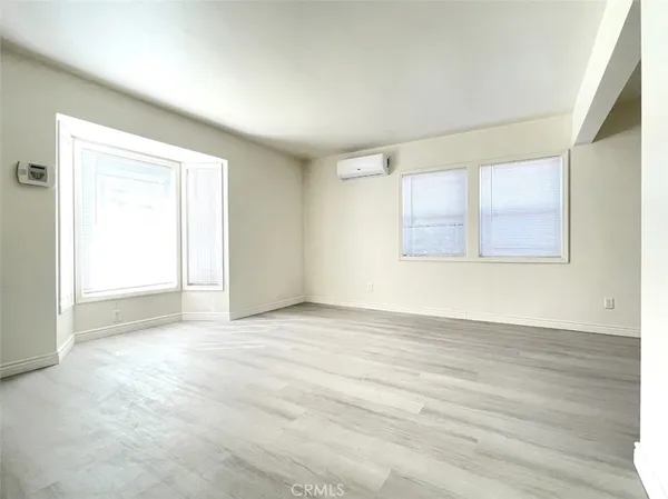 a large bathroom with a tub a sink and a large mirror