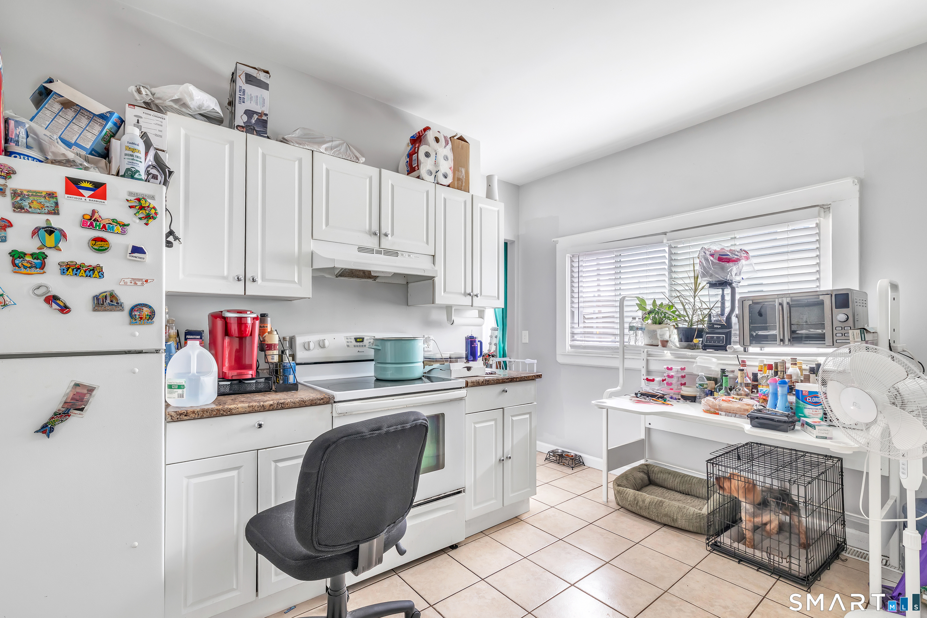 189 Wells Street Bridgeport, CT 06606 - Photo 35 of 40 1st Floor - Offers 1389 sq ft -Kitchen offers white cabinets, electric stove, fridge, own washer/dryer