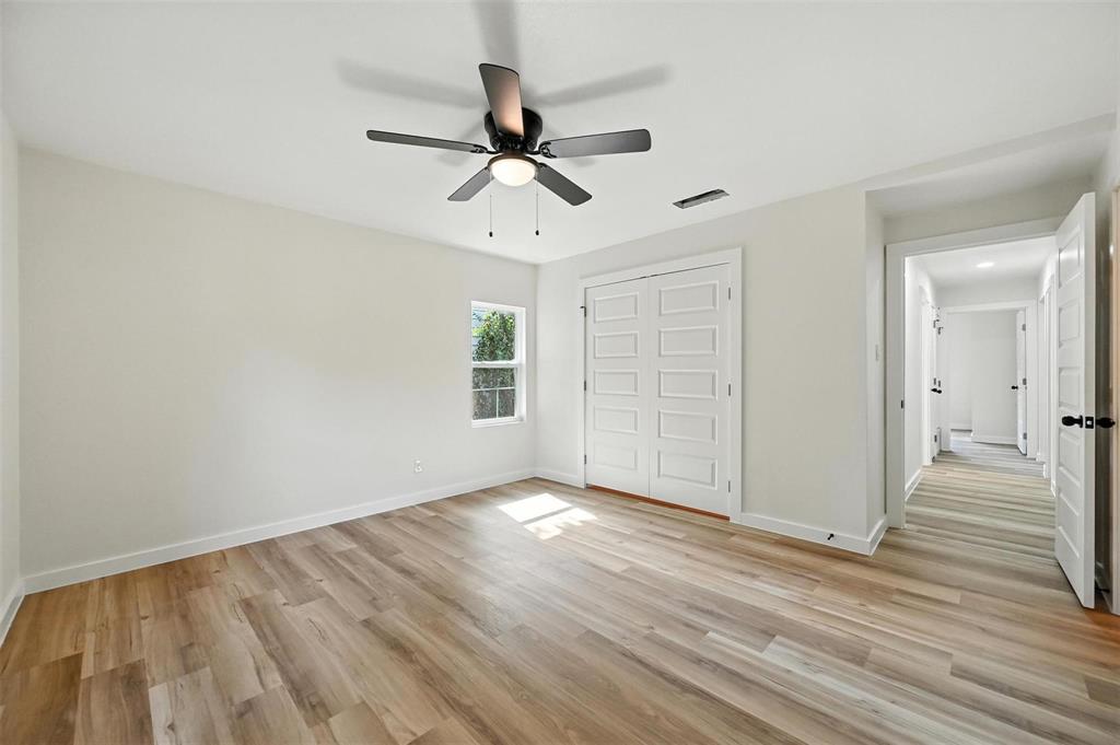 4413 Quails Lane Fort Worth, TX 76119 - Photo 13 of 20 wooden floor in an empty room with a window