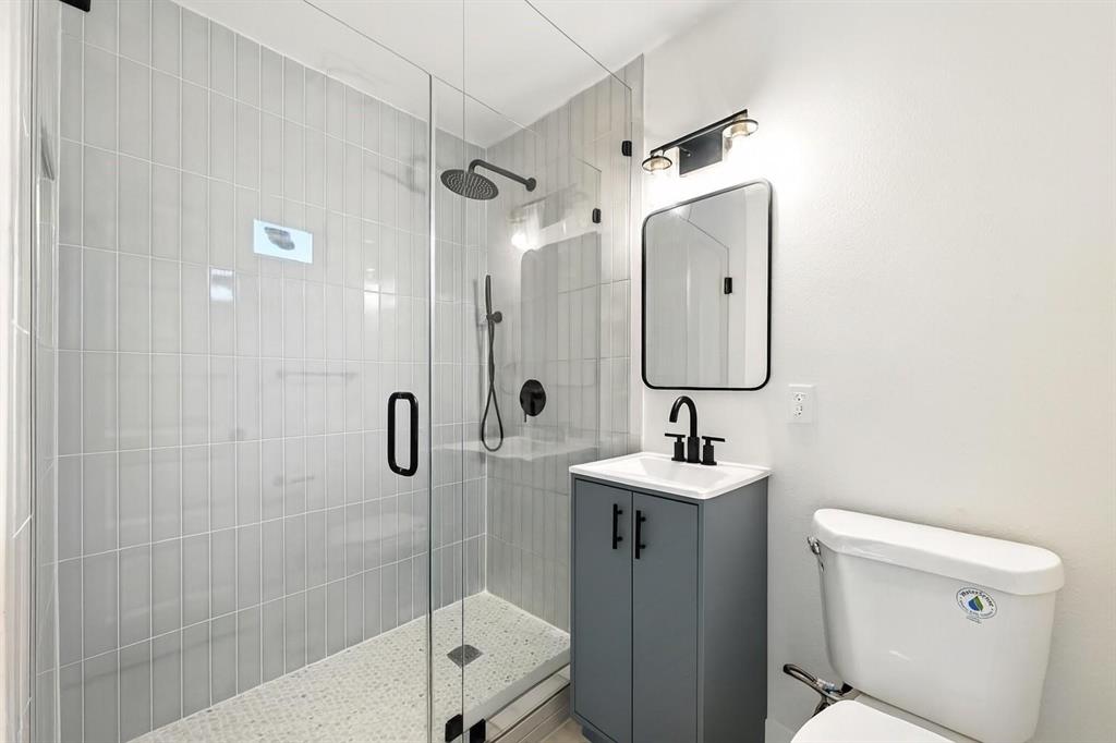 4413 Quails Lane Fort Worth, TX 76119 - Photo 14 of 20 a bathroom with a sink toilet and shower