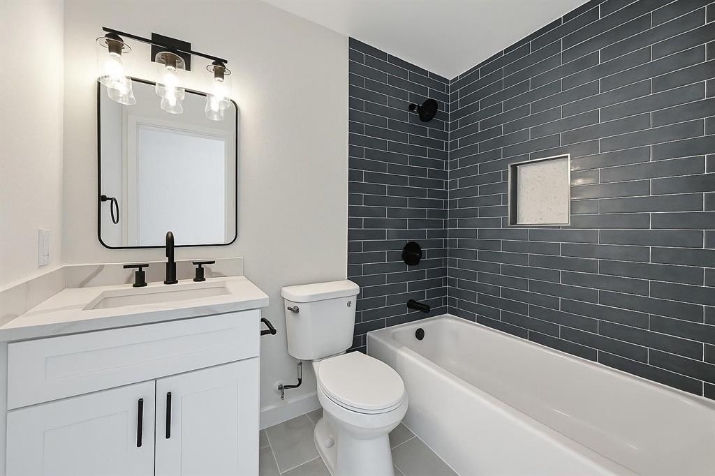 4413 Quails Lane Fort Worth, TX 76119 - Photo 17 of 20 a bathroom with a sink toilet and shower