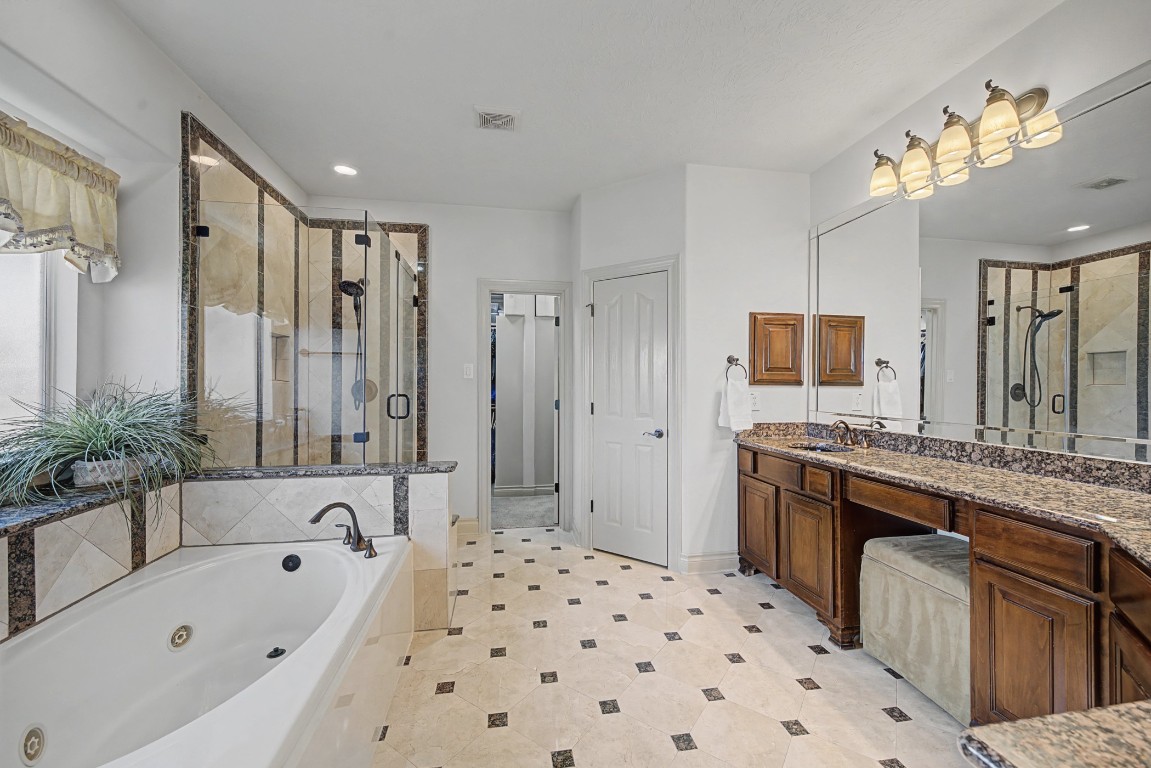 27223 Blue Cedar Lane Spring, TX 77386 - Photo 29 of 50 a bathroom with a bathtub sink and mirror