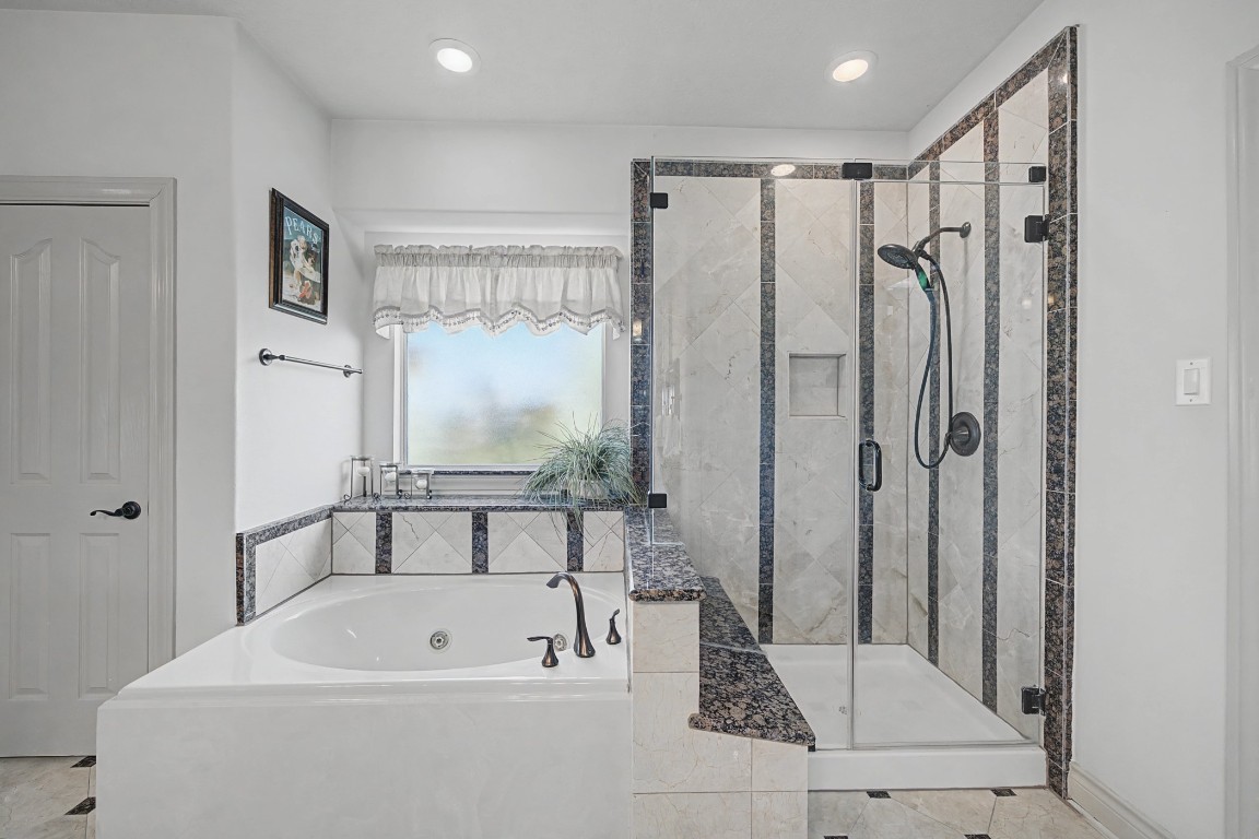 27223 Blue Cedar Lane Spring, TX 77386 - Photo 30 of 50 a bathroom with a bathtub a shower a sink and a mirror