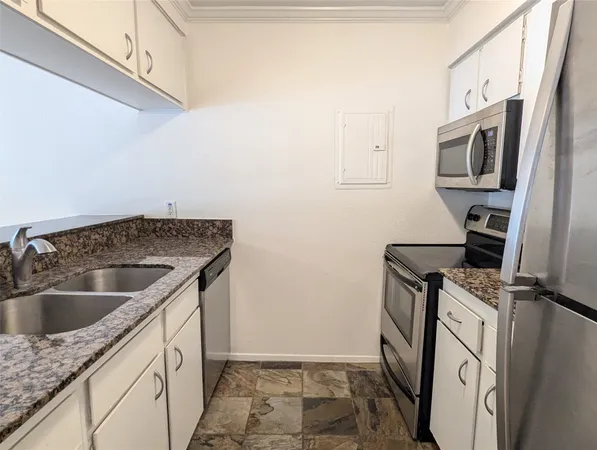 a view of a room with wooden floor and chandelier