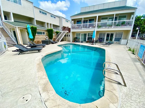 a view of a patio with chair and tables