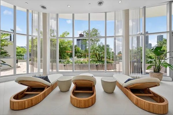 a room with furniture and a large window