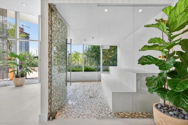 a room with potted plants and a fountain