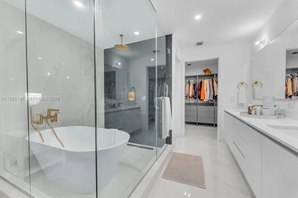 a bathroom with a tub and shower