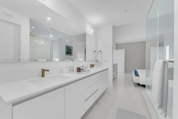 a bathroom with a sink a mirror and a shower