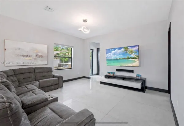a living room with furniture and a flat screen tv