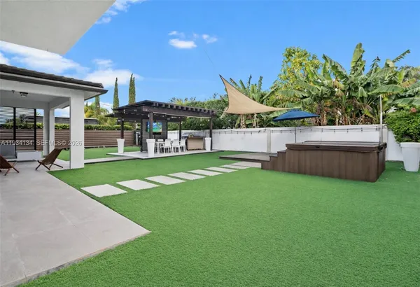 a view of an house with backyard and porch