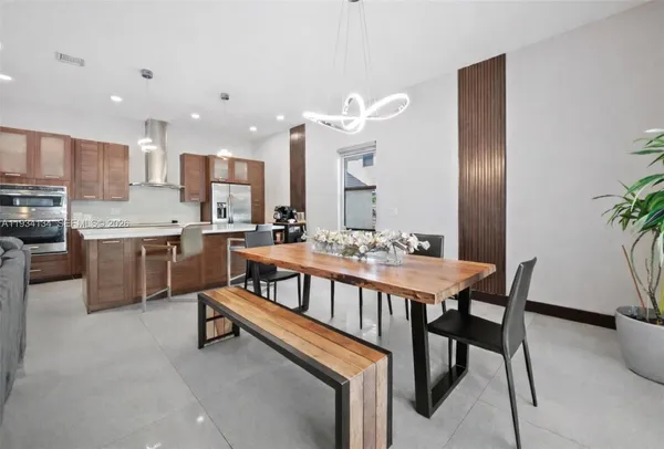 a dining room with furniture and a kitchen view