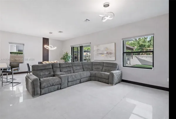 a living room with furniture and a large window