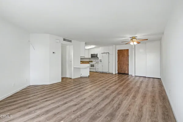 a view of a kitchen with a sink and a refrigerator