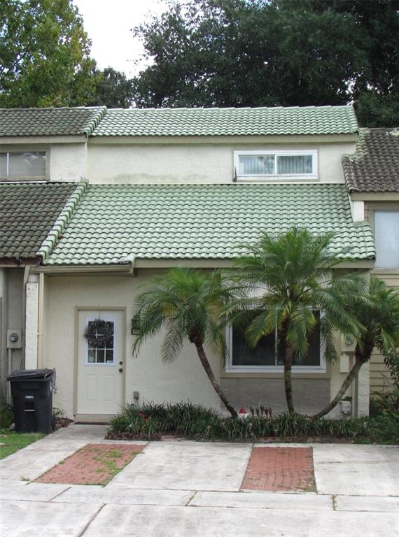 a front view of a house with plants