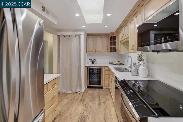 a kitchen with white cabinets and sink
