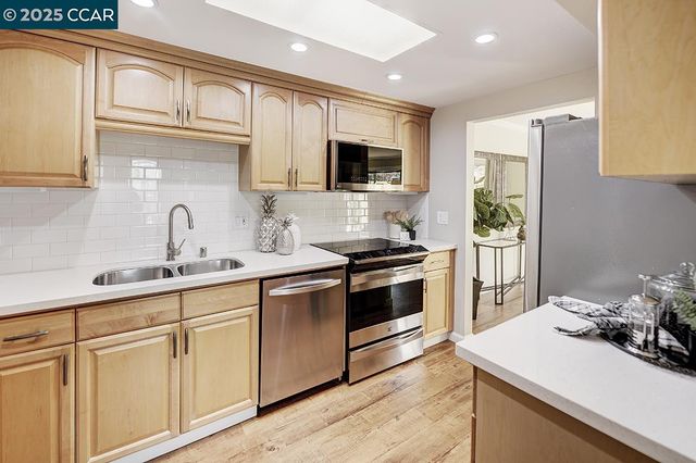 a kitchen with a sink and cabinets